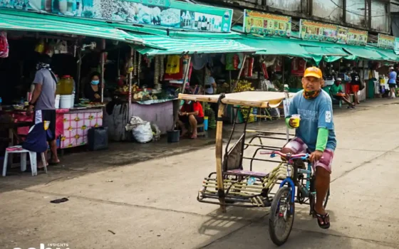 Tricycle driver passing along the Carbon Public Market