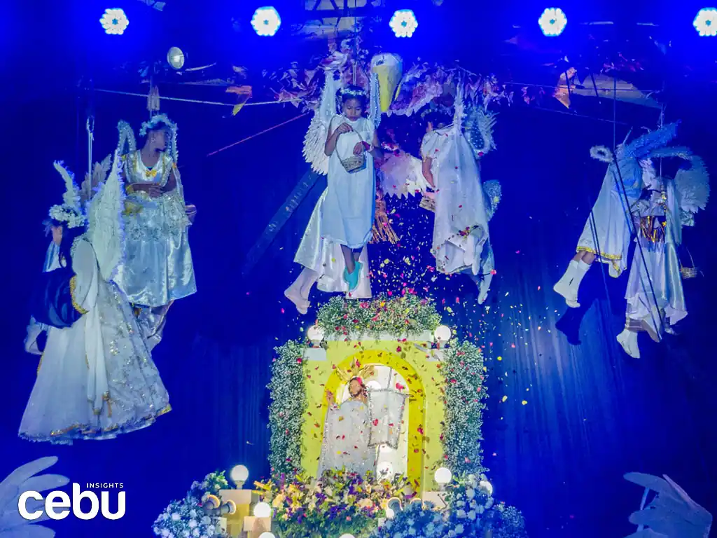 Children dressed up as angels drop flower petals to an image of Mama Mary at the Sugat Kabanhawan in Minglanilla.