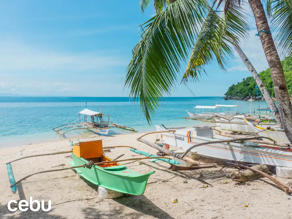 Boats at the shore of the Hermit’s Cove, what you'll experience retiring in Cebu