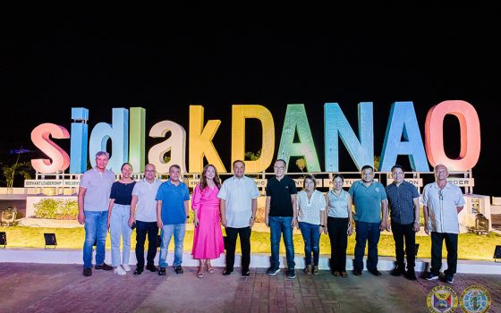 Government officials pose right in front of the sidlak Danao signage