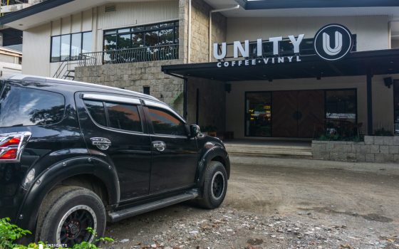A car parked in front of Unity Coffee & Vinyl, a new cafe for breakfast in Cebu